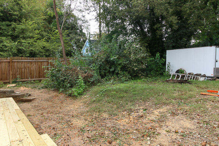 before backyard transformation with trailer and dirt hill