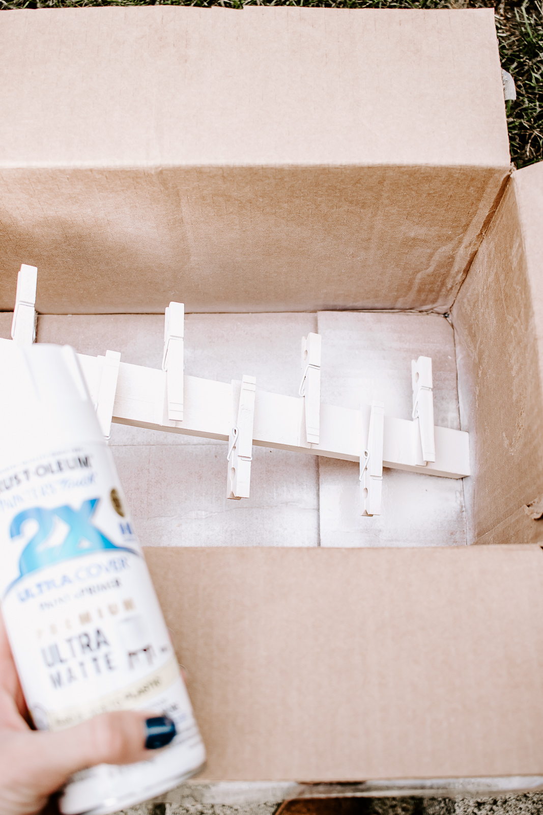spray paint wall organizer in cardboard box