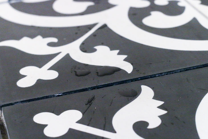Water beading up on cement tiles means it's ready to grout.