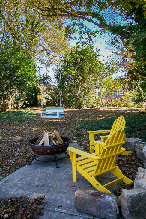 yellow adirondack chairs around fire pit