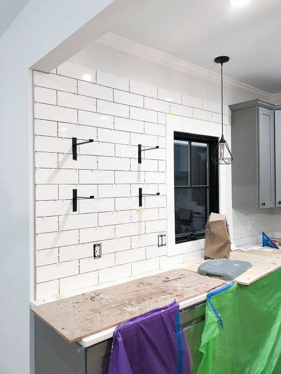subway tile backsplash being installed