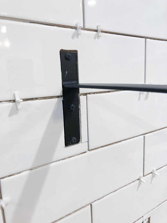 tile around shelf bracket