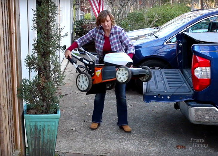 Brittany lifting mower into truck unassisted