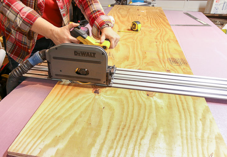 using DeWalt battery-powered track saw to cut plywood