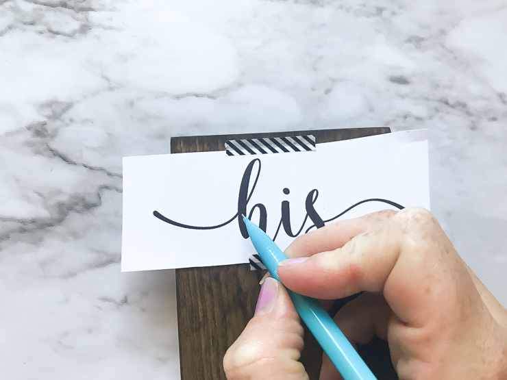 Use a pencil to trace over text onto the wood