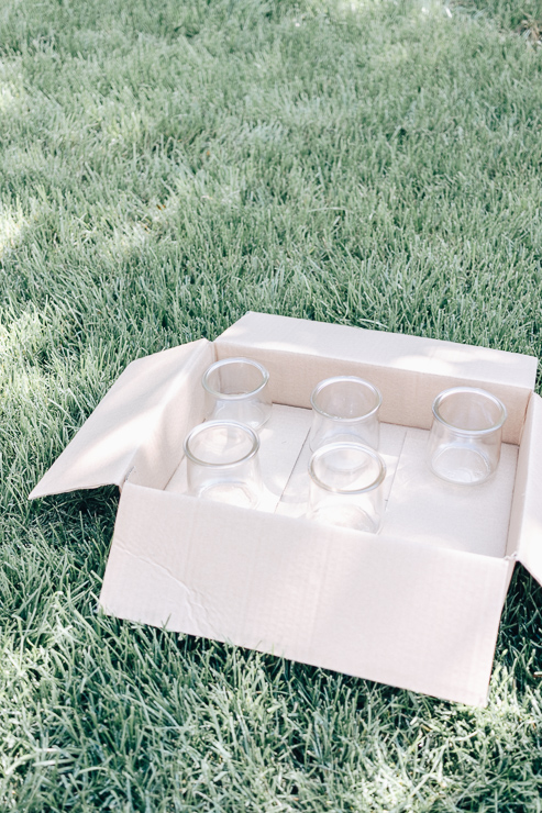 Place jars in a box to prepare for spray painting