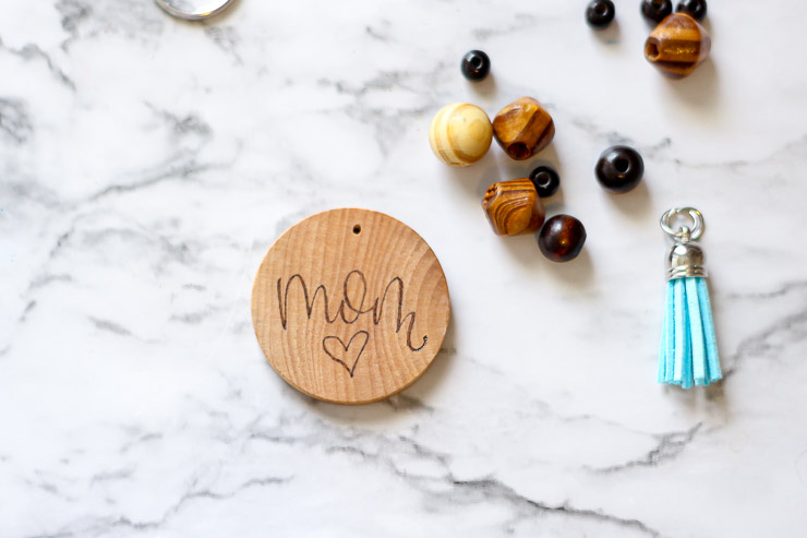 Personalized keychain assembly with a wood burned design