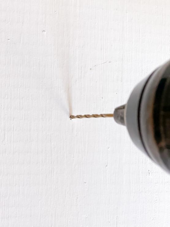 Drill small pilot holes for the house number screws to avoid splitting the wood