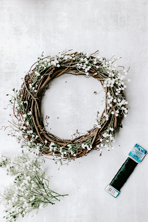 Use floral wire to secure florals to wreath