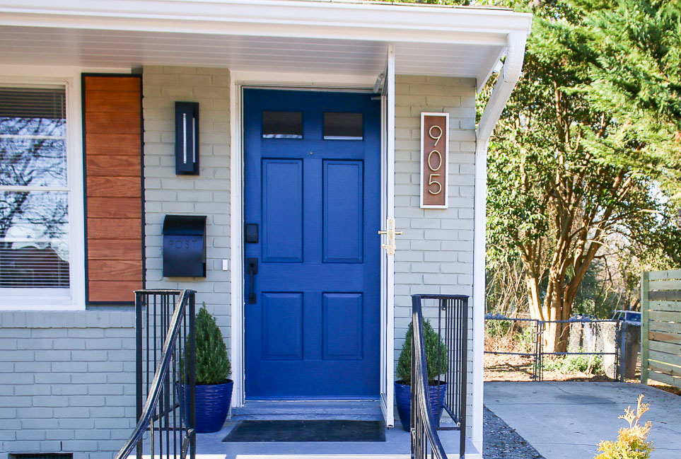 Loyal Blue by Sherwin Williams - Modern Ranch house with sage siding and royal blue door