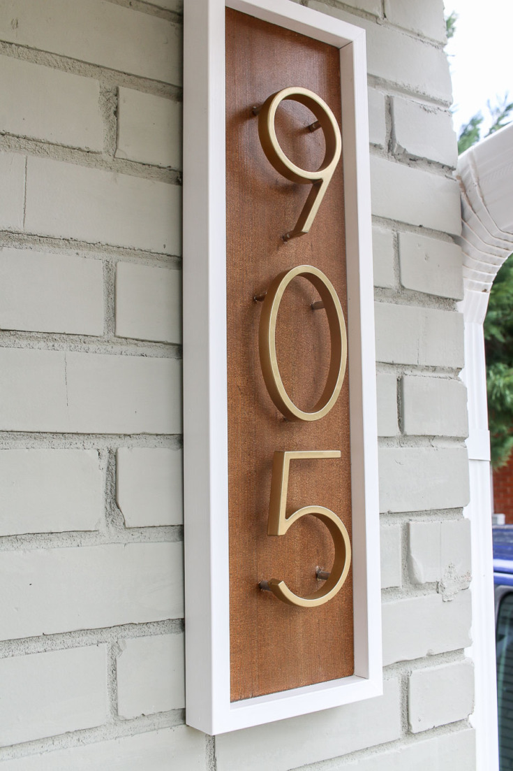 modern house number sign on brick