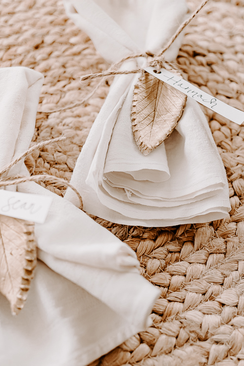 napkins tied with jute twine and clay leaves with names