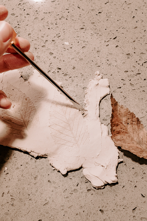 cutting out leaves from clay