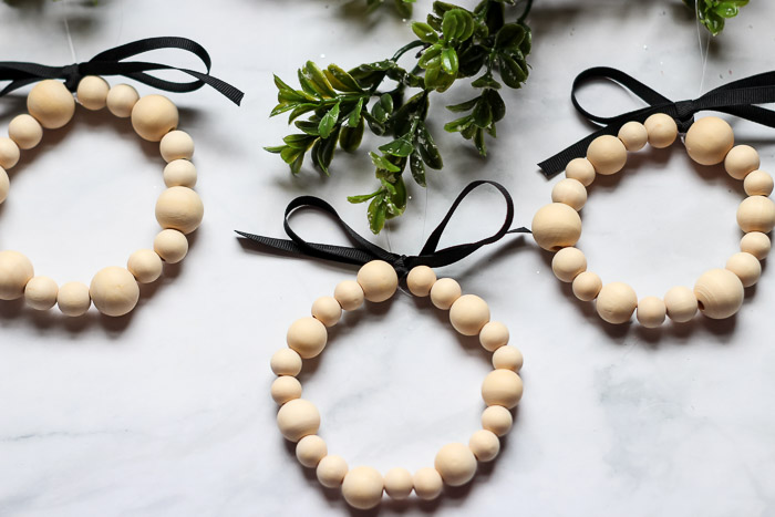 wooden bead ornaments on green branch