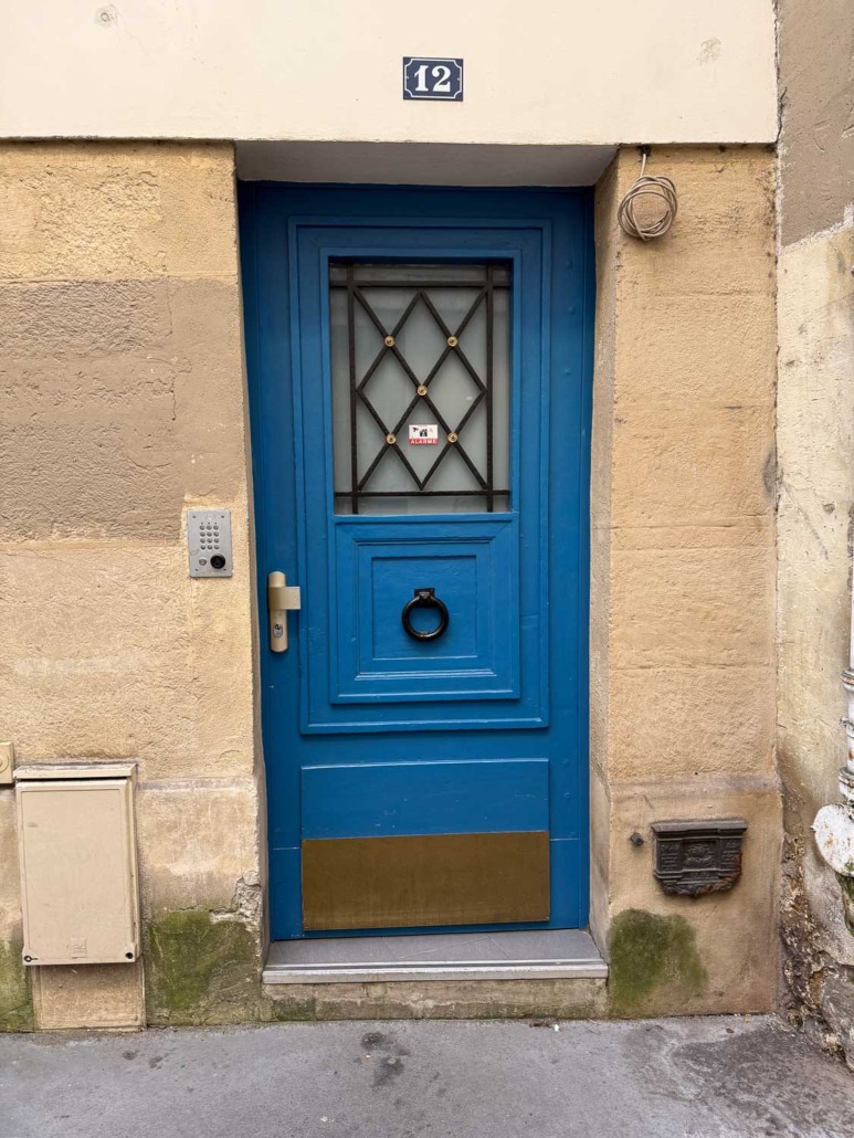 Blue Chip by Sherwin Williams - Cute royal blue door in France with diamond iron grill over window