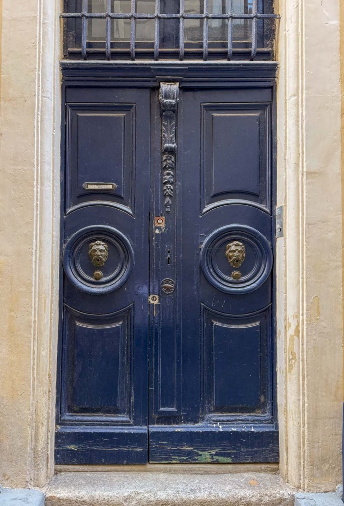 Bold Blue by Benjamin Moore - Dark blue violet double doors with centered door knobs shot in France