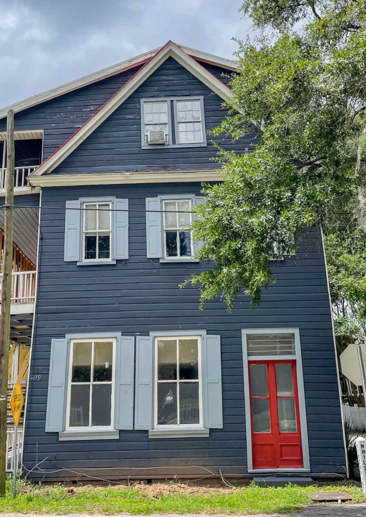 Classic Red by Valspar - 3 story Old house with navy siding, light blue shutters, and bright red door