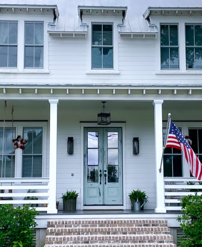 Harbor Haze by Benjamin Moore - South Carolina coastal house with front porch, dormer windows, and light blue double glass door.