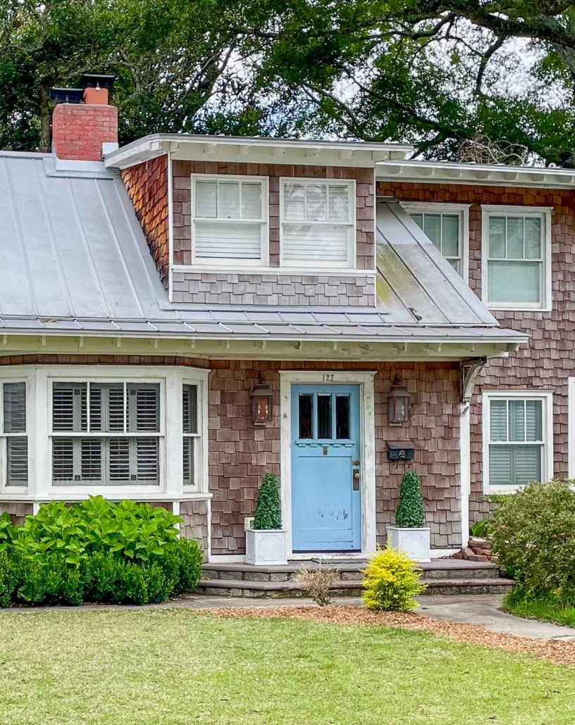 Undercool by Sherwin Williams - Cape Code style house with bright blue front door and cedar shake siding